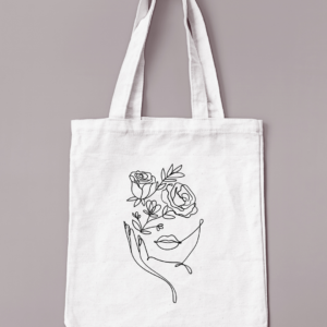 Sac réutilisable de couleur crème avec un visage fleuri floqué en noir