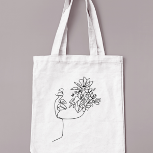 Sac réutilisable de couleur crème avec un visage fleuri floqué en noir