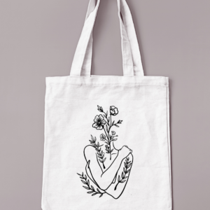 Sac réutilisable de couleur crème avec un buste de femme avec une tête fleurie floqué en noir